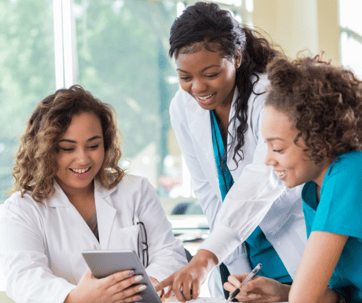 Two peer mentors helping a student nurse